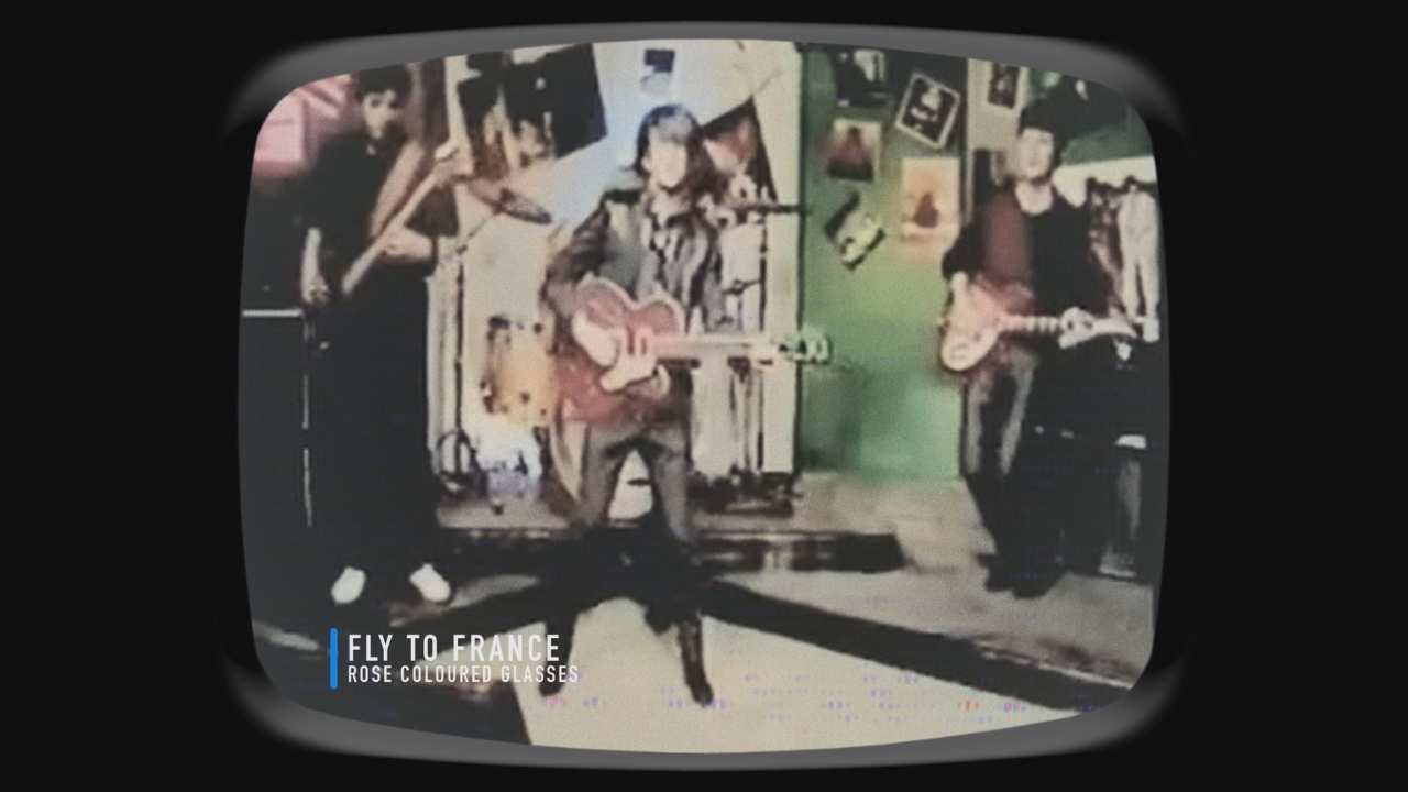 a television with three men playing music